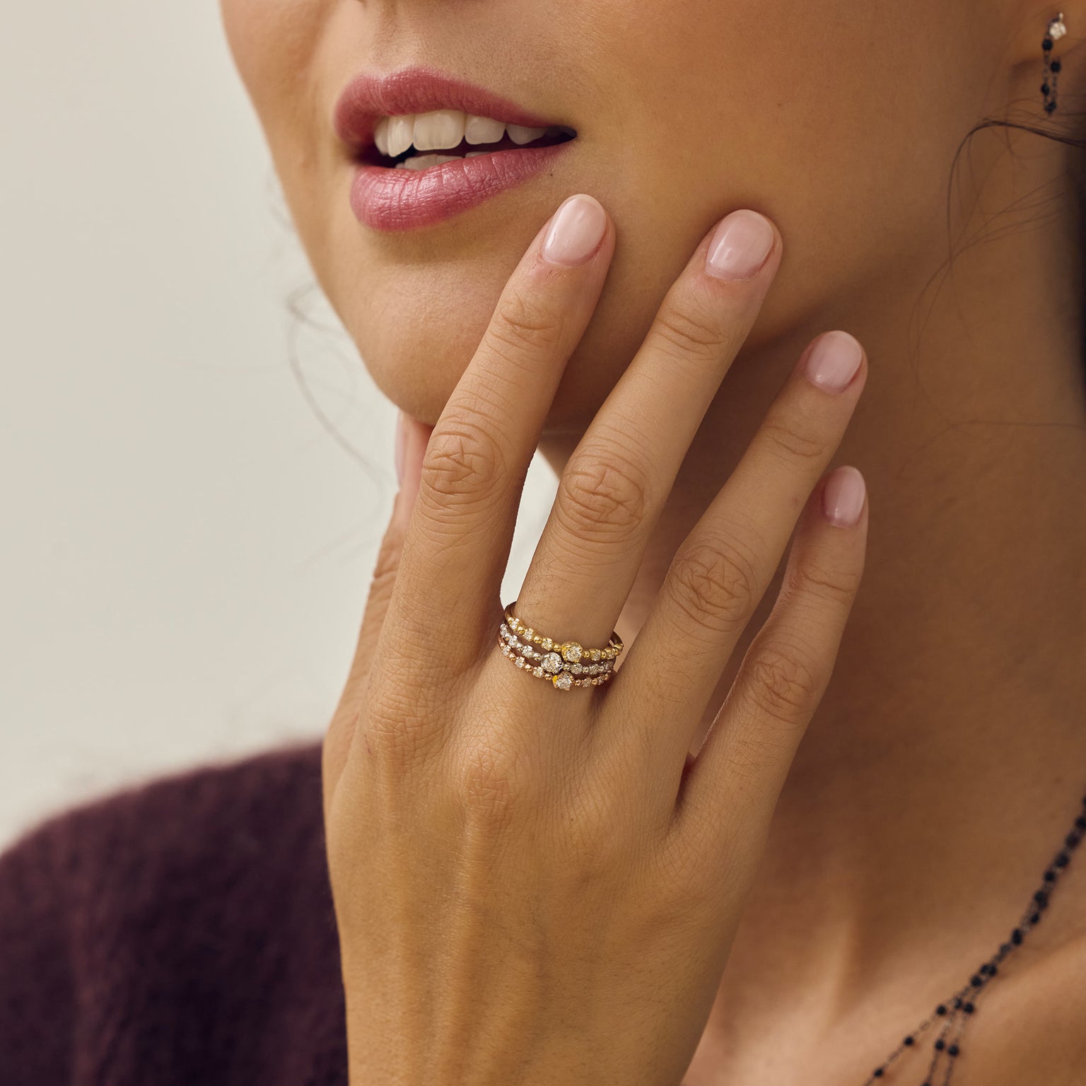 Main d’une femme portant des bagues solitaires Gigi Clozeau.
