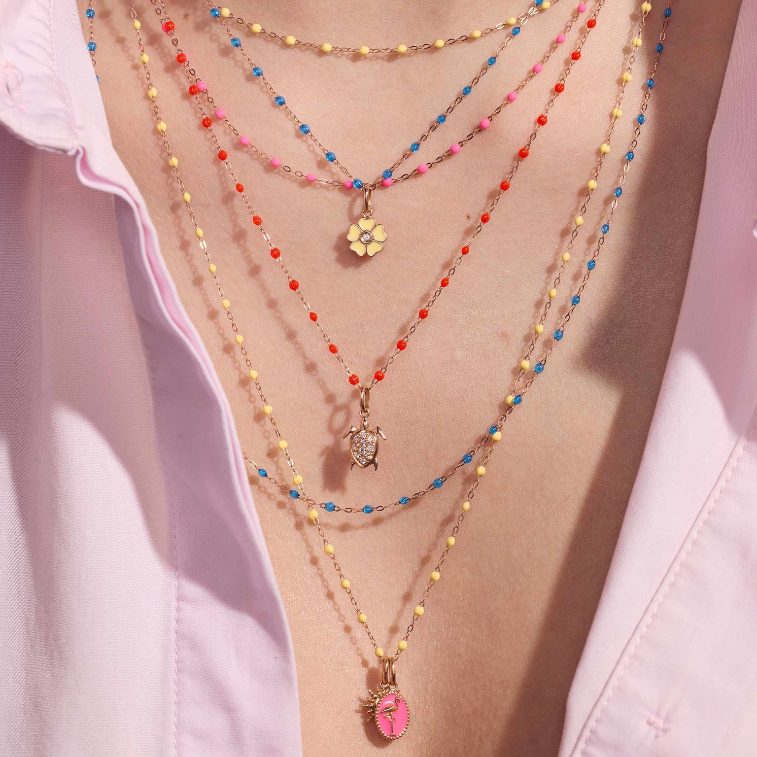 Photo du décolleté d’une femme portant différents colliers colorés Gigi Clozeau.